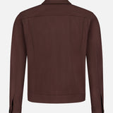 The THEORY River Twill Trucker Jacket is shown from the back, with a straight hem, buttoned cuffs, long sleeves, and a minimalist design made from breathable performance fabric against a white background.