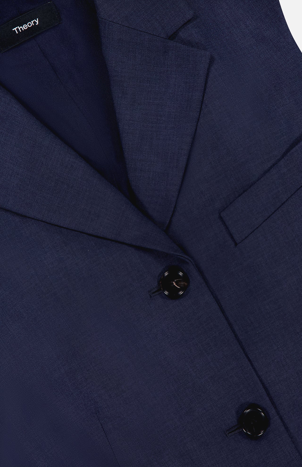 Close-up of the THEORY 3 Button Sleeveless Vest in navy, featuring three black buttons, a notched lapel, and a chest pocket—ideal for women's summer office suiting. The label inside the collar displays THEORY.