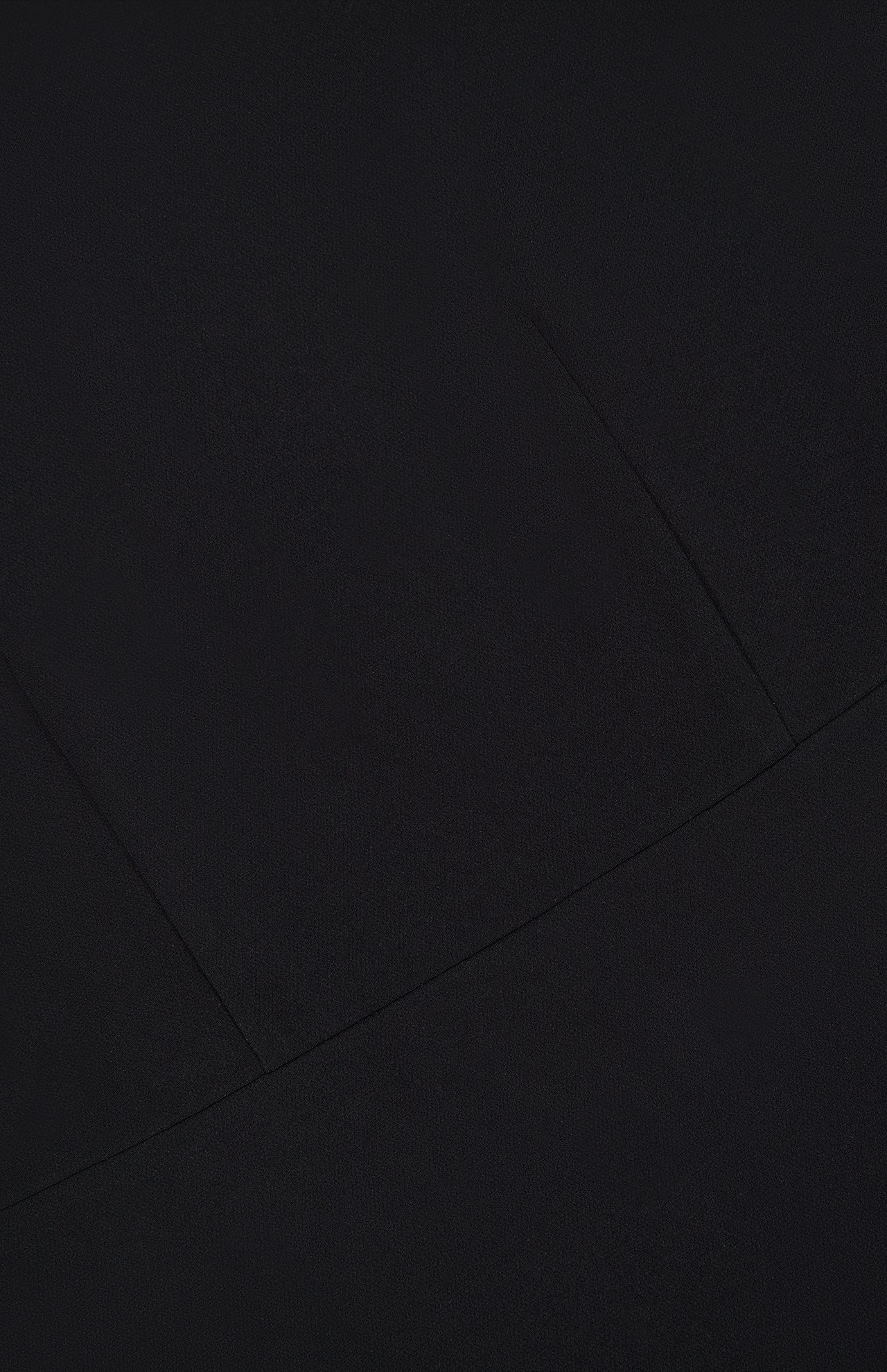 Close-up of a black Theory Admiral Varetta Midi Dress with visible seams forming a geometric pattern on the fabric.