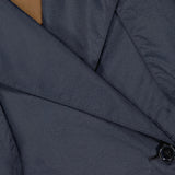 Close-up of the THEORY Airy Nylon Trench Coat in dark gray, double-breasted with shiny black buttons and textured fabric—sleek lapel details make it a perfect capsule wardrobe essential.