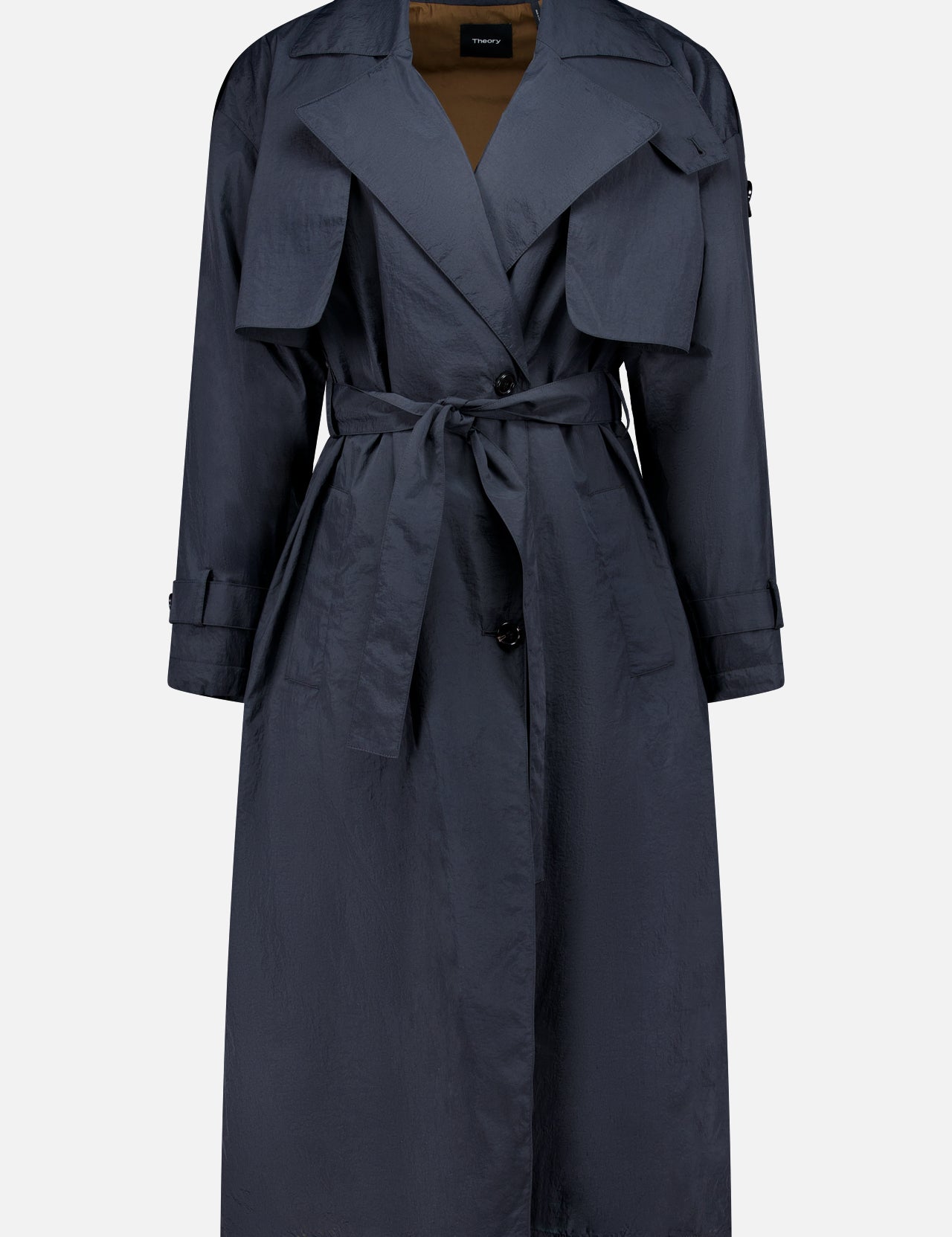 THEORY’s Airy Nylon Trench Coat, a dark blue knee-length double-breasted design with a belted waist, wide lapels, button closure, front flap pockets, and long sleeves, is shown against a plain white background.
