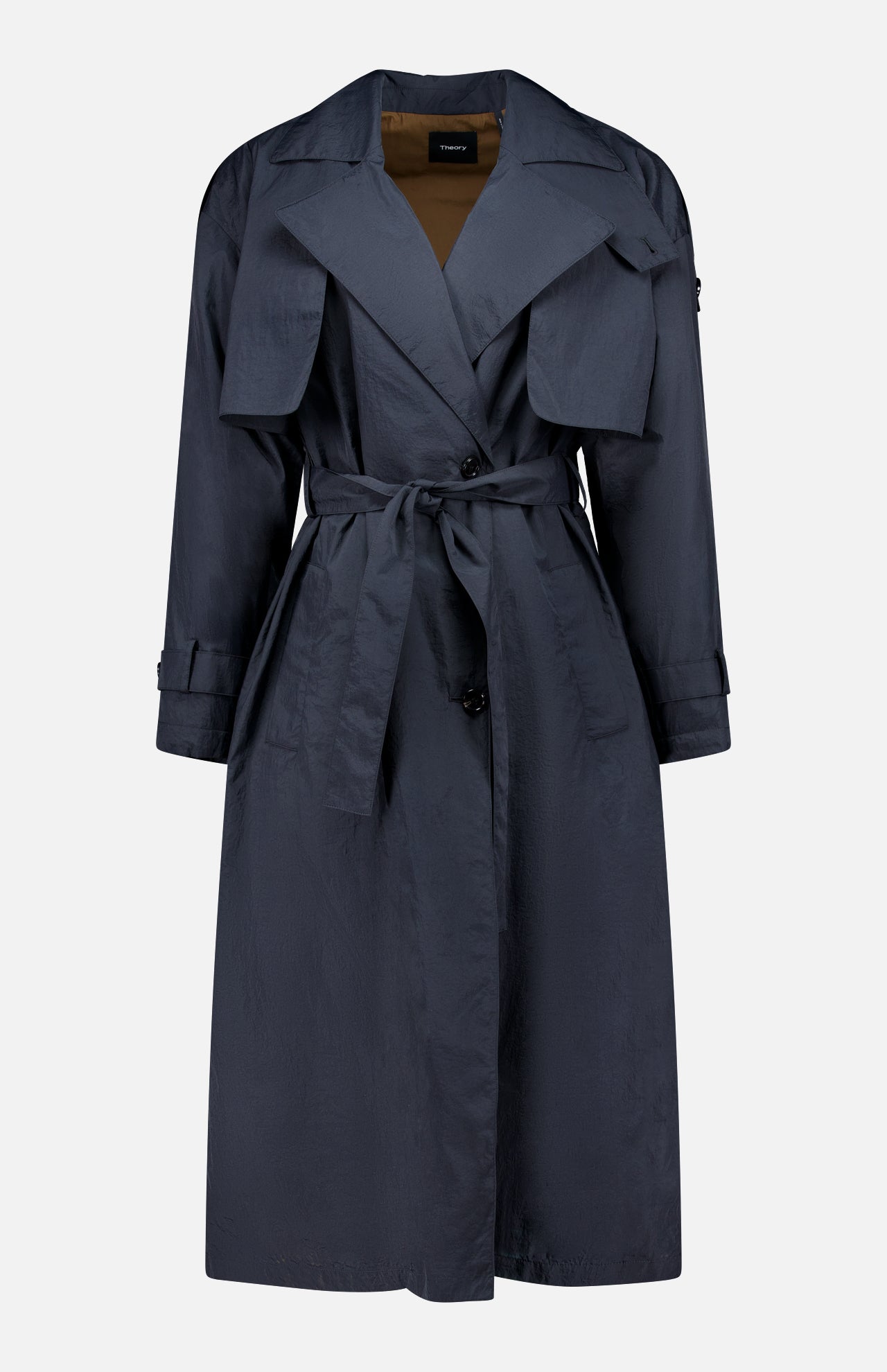 THEORY’s Airy Nylon Trench Coat, a dark blue knee-length double-breasted design with a belted waist, wide lapels, button closure, front flap pockets, and long sleeves, is shown against a plain white background.