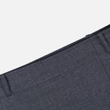 Close-up of the waistband and belt loops on the THEORY Aline Pleated Mini Skirt in dark gray wool-blend, set against a plain white background.