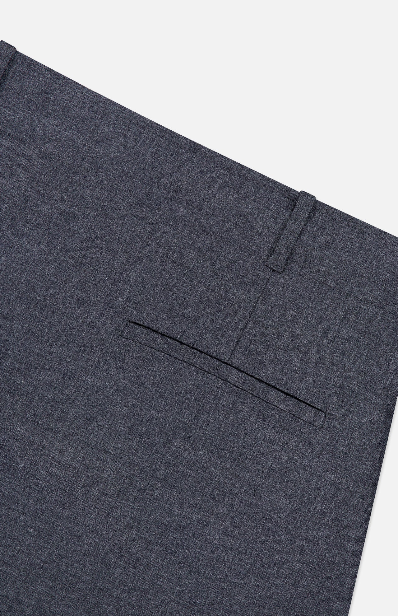 Close-up of the back pocket and waistband of the THEORY Aline Pleated Mini Skirt in dark gray wool-blend, shown against a white background. The skirt features a welt-style back pocket and a visible belt loop above it.