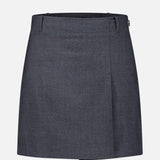 THEORY Aline Pleated Mini Skirt in dark gray, featuring a knee-length silhouette with belt loops and a subtle front fold, displayed on a plain white background.
