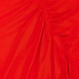 A close-up of the THEORY Asymmetrical Ruched Tank Dress in bright red shows gathered, diagonal ruching that creates textured folds—an elegant detail, perfect for casual wear.