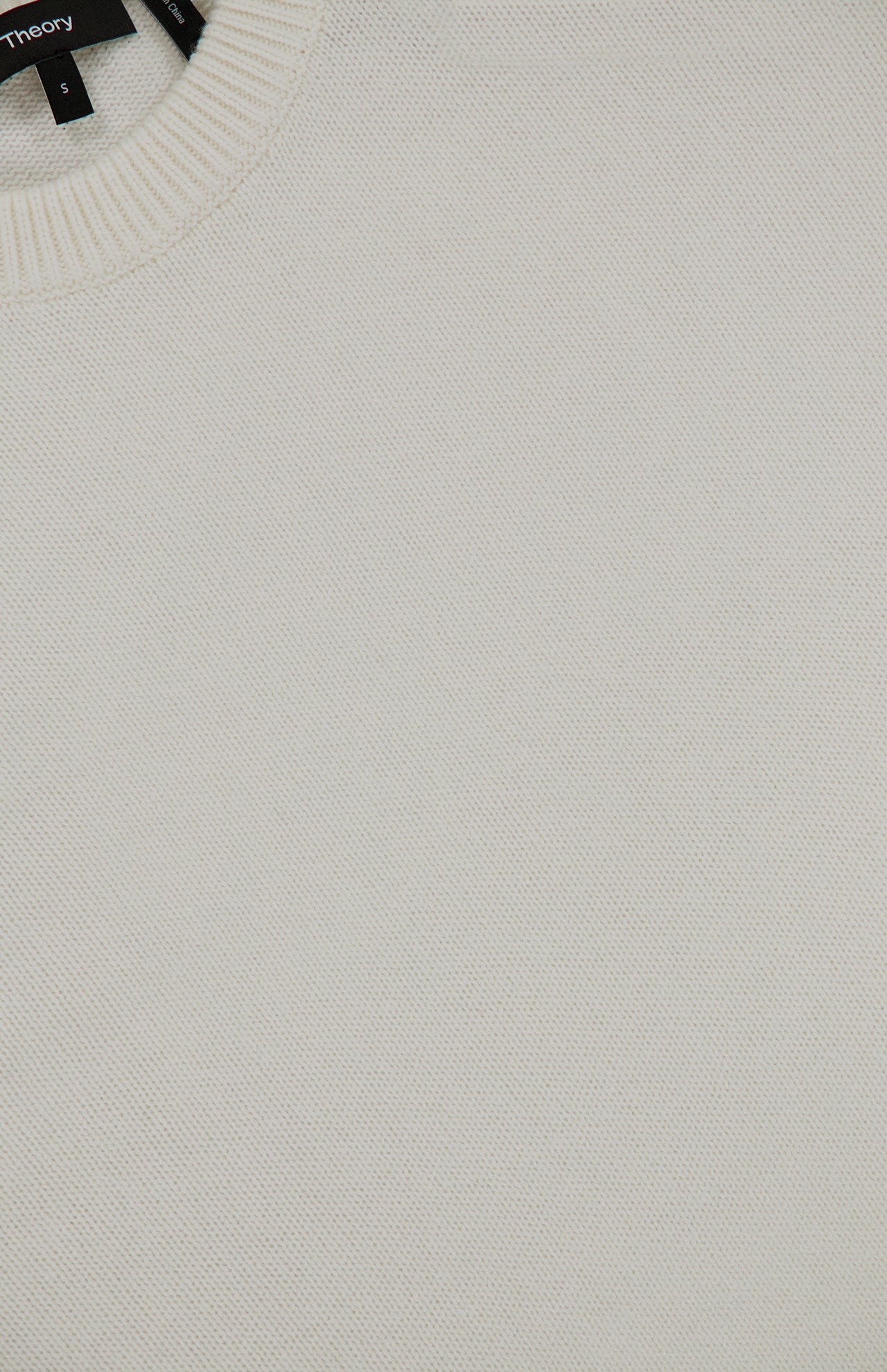 Off-white Theory Cashmere Crew Neck Sweater in a quiet luxury style with a size small tag at the neckline.
