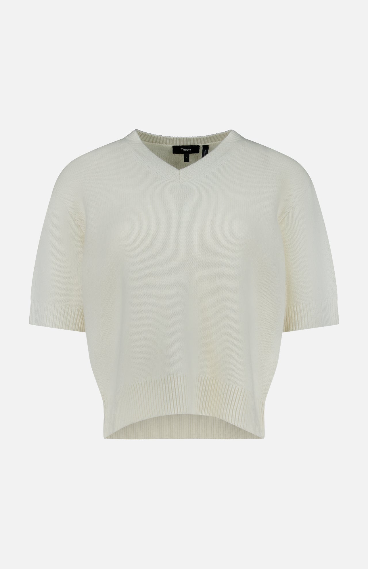 The THEORY Cashmere Cropped V-Neck T-Shirt is a short-sleeved, cream-colored knit sweater featuring a slightly cropped t-shirt silhouette and a V-neck, shown against a plain white background.