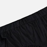 Close-up of the THEORY Curved Yoke Circle Skirt in black, featuring a gathered fabric and elastic waistband for an easy pull-on style, shown against a plain white background.