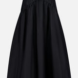 The THEORY Curved Yoke Circle Skirt is a black, knee-length A-line skirt with a gathered waist and pull-on design, shown against a plain white background.