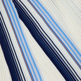 The DRAPE NECK STRIPE TANK DRESS by THEORY showcases an abstract pleated cream fabric accented with diagonal navy blue, sky blue, and fine red stripes. This dynamic interplay of colors and textured folds elevates the classic tank dress silhouette, capturing the movement and structure reminiscent of a fit-and-flare style.