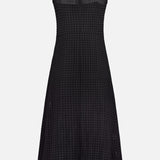 The THEORY Easy Curve Eyelet Dress is a sleeveless black cotton-lined midi with a fitted bodice and flared skirt, featuring an all-over eyelet pattern. Shown from the back against a white background.