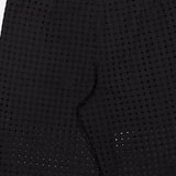 Close-up of THEORY's Easy Eyelet Slim Fit Pant in black embroidered eyelet cotton, featuring a perforated circular pattern, tailored fit, side pockets, and semi-sheer detailing.