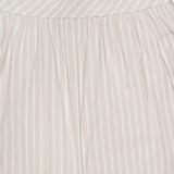 Close-up of the THEORY Front Vented Volume Striped Skirt, featuring light beige cotton-blend fabric with vertical neutral stripes, a gathered waistband, and a clean, tailored design.