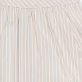 Close-up of the THEORY Front Vented Volume Striped Skirt, an A-line midi in a cotton blend with neutral vertical stripes and diagonal waistband detailing.