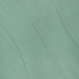 Close-up of the THEORY Linen Apron Mini Dress in sage green, featuring visible stitching and seams that form curved and straight lines across the textured fabric.