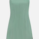 The THEORY Linen Apron Mini Dress is a sage green, sleeveless mini dress with thin straps, subtle vertical seams, and a side slit. This fitted summer dress is crafted from a linen-blend and shown against a white background.