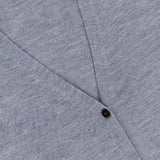 Close-up of the THEORY Long Merino Wool Cardigan in light grey, featuring a V-neckline, two dark buttons, and a visible black label in the top left corner.