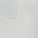 Close-up of a white Merino Slim Tank Top by THEORY, featuring ribbed edging on the neckline and armholes. A black THEORY tag is visible at the top left.