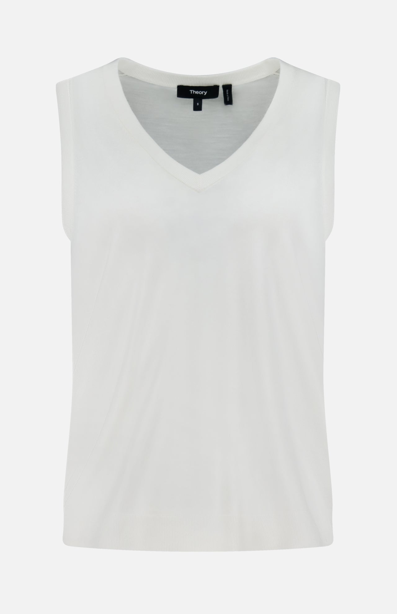 The THEORY Merino Slim Tank Top is a sleeveless white piece with a relaxed V-neck fit, made from smooth, lightweight Merino wool and showcases a simple, minimalist design.