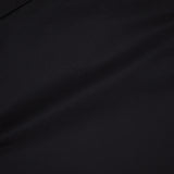 A close-up of THEORY's Open Sleeve Boatneck Top in smooth black fabric, with subtle folds and a boat neck—embodying quiet luxury.
