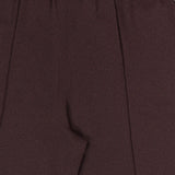Close-up of the THEORY Pintuck Pull-On Pant in maroon, featuring an elastic waistband and a distinct pintuck seam down the front. The silky smooth fabric offers a subtle textured finish for a refined appearance. Image focuses on the upper portion and part of the leg.