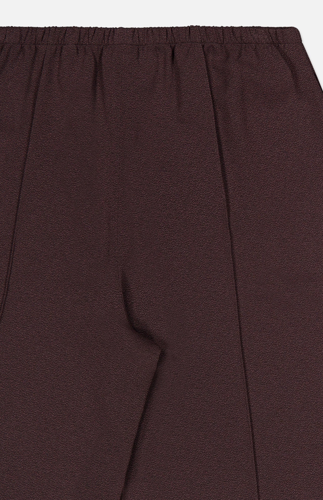 Close-up of the THEORY Pintuck Pull-On Pant in maroon, featuring an elastic waistband and a distinct pintuck seam down the front. The silky smooth fabric offers a subtle textured finish for a refined appearance. Image focuses on the upper portion and part of the leg.