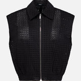 THEORY Eyelet Zip Vest—a sleeveless, collared black top made from perforated grid-patterned fabric—shown on a plain white background for a bold statement look.