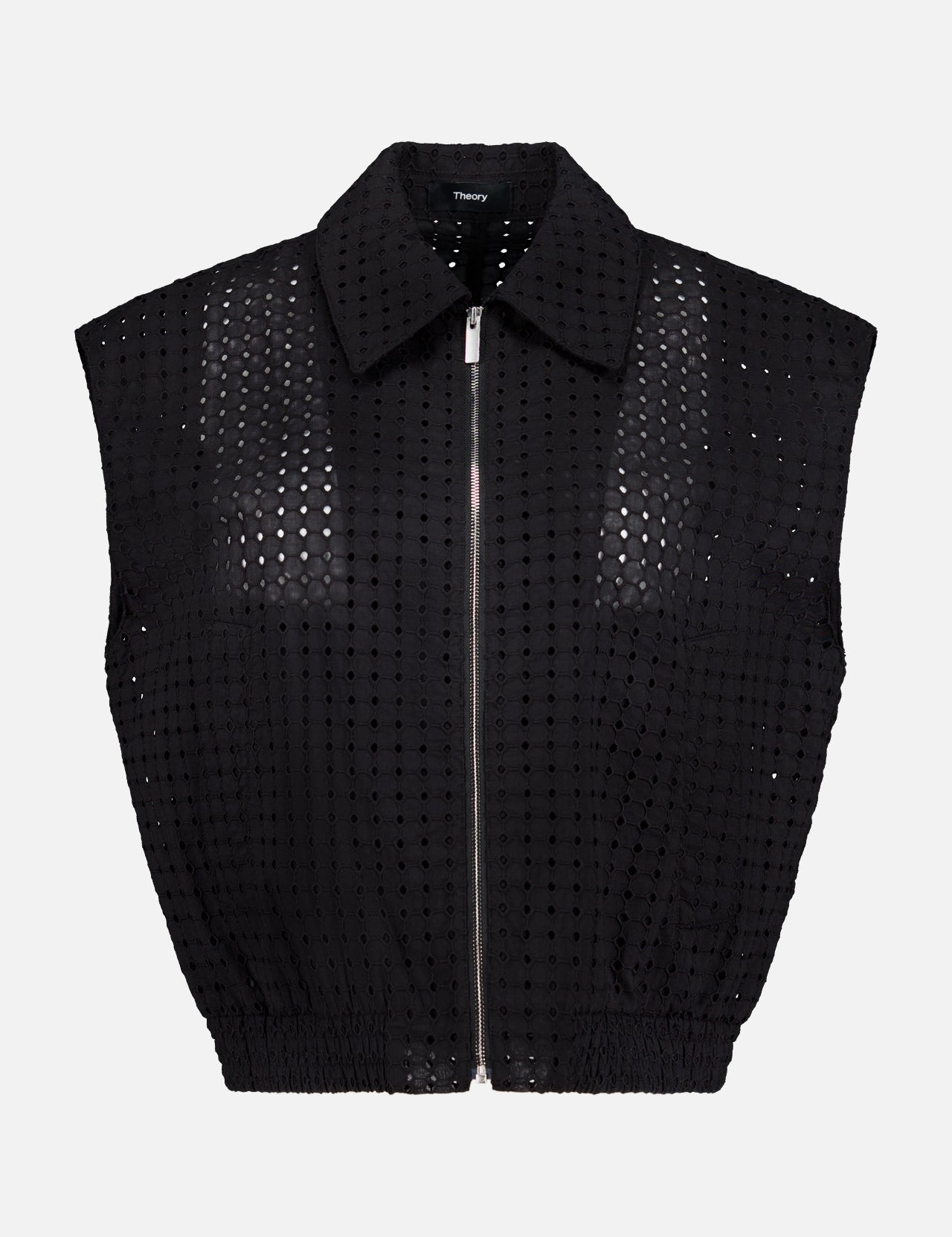 THEORY Eyelet Zip Vest—a sleeveless, collared black top made from perforated grid-patterned fabric—shown on a plain white background for a bold statement look.