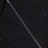 Close-up of the THEORY Eyelet Zip Vest, a black statement top in textured fabric with small eyelets and a bold silver zipper running diagonally.