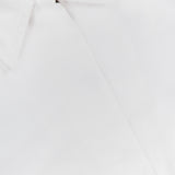 Close-up of the THEORY Relaxed Flyer Jacket, a white cotton-blend piece with crisp, smooth fabric. Features include a sharp collar and pocket flap, offering lightweight warmth and displaying the signature THEORY label.