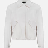 The THEORY Relaxed Flyer Jacket is a white, long-sleeve, collared cotton-blend piece with a cropped fit, front flap pockets, and elasticated cuffs, providing lightweight warmth and shown against a plain white background.