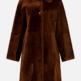 Theory Reversible Shearling Trench Coat in dark brown, featuring a knee-length fit, fold-over collar, and four front buttons.