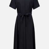 THEORY’s Short Sleeve Belted A-Line Dress features a black, collared design with short sleeves and a button-up front. The matching fabric belt ties at the waist for flattering definition, while the gently flared A-line skirt creates an effortlessly chic and timeless silhouette.