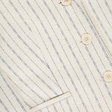 Close-up of the THEORY Shrunken 3 Button Jacket in cream, featuring thin dark pinstripes, beige buttons, a front pocket, textured crepe fabric, and visible stitching.