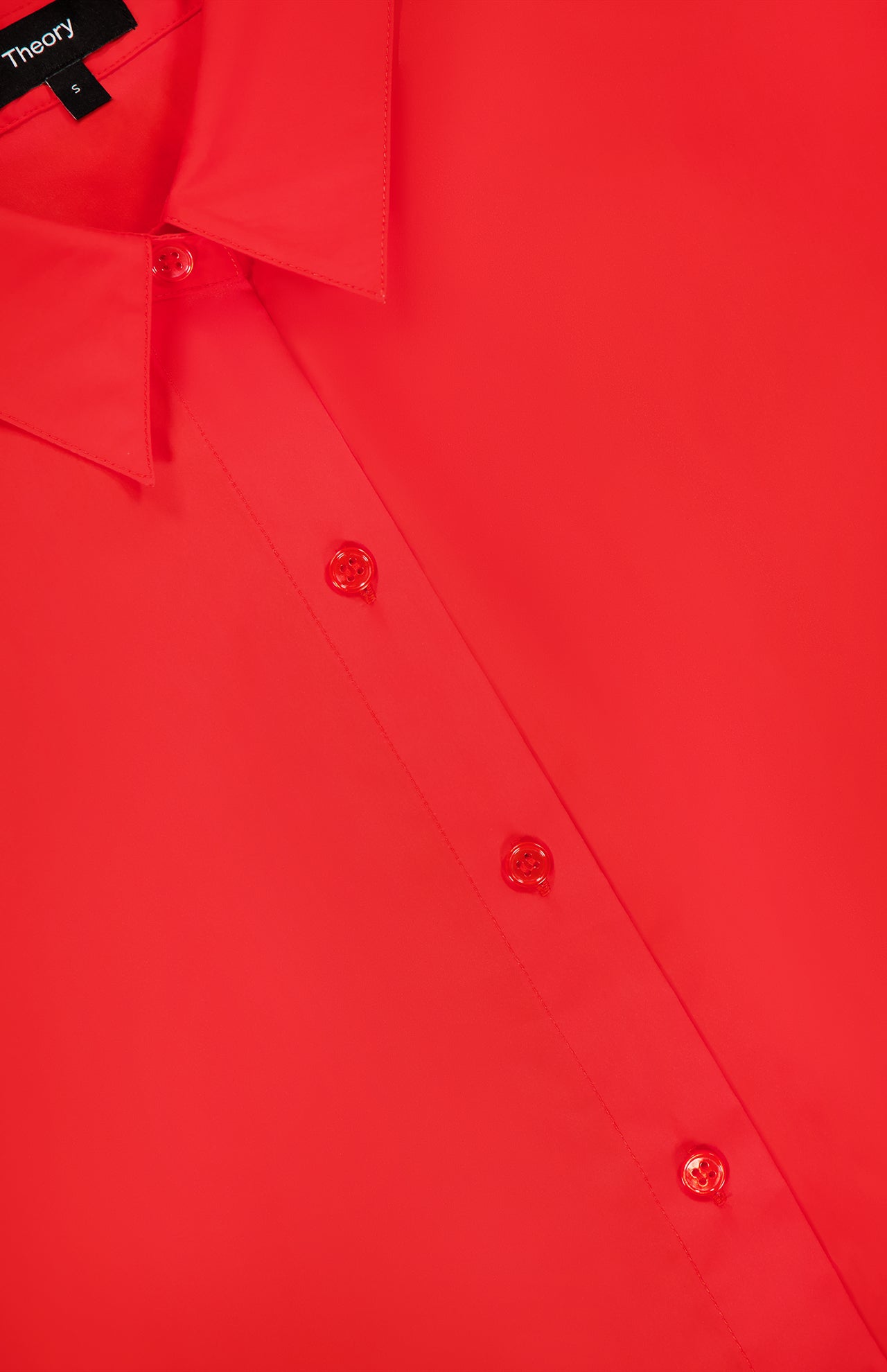 Close-up of the THEORY Sleeveless Cropped Elastic Shirt in red, ideal for office wear, featuring four buttons, part of the collar, and a partial black label with white text displaying size 6 at the top left.