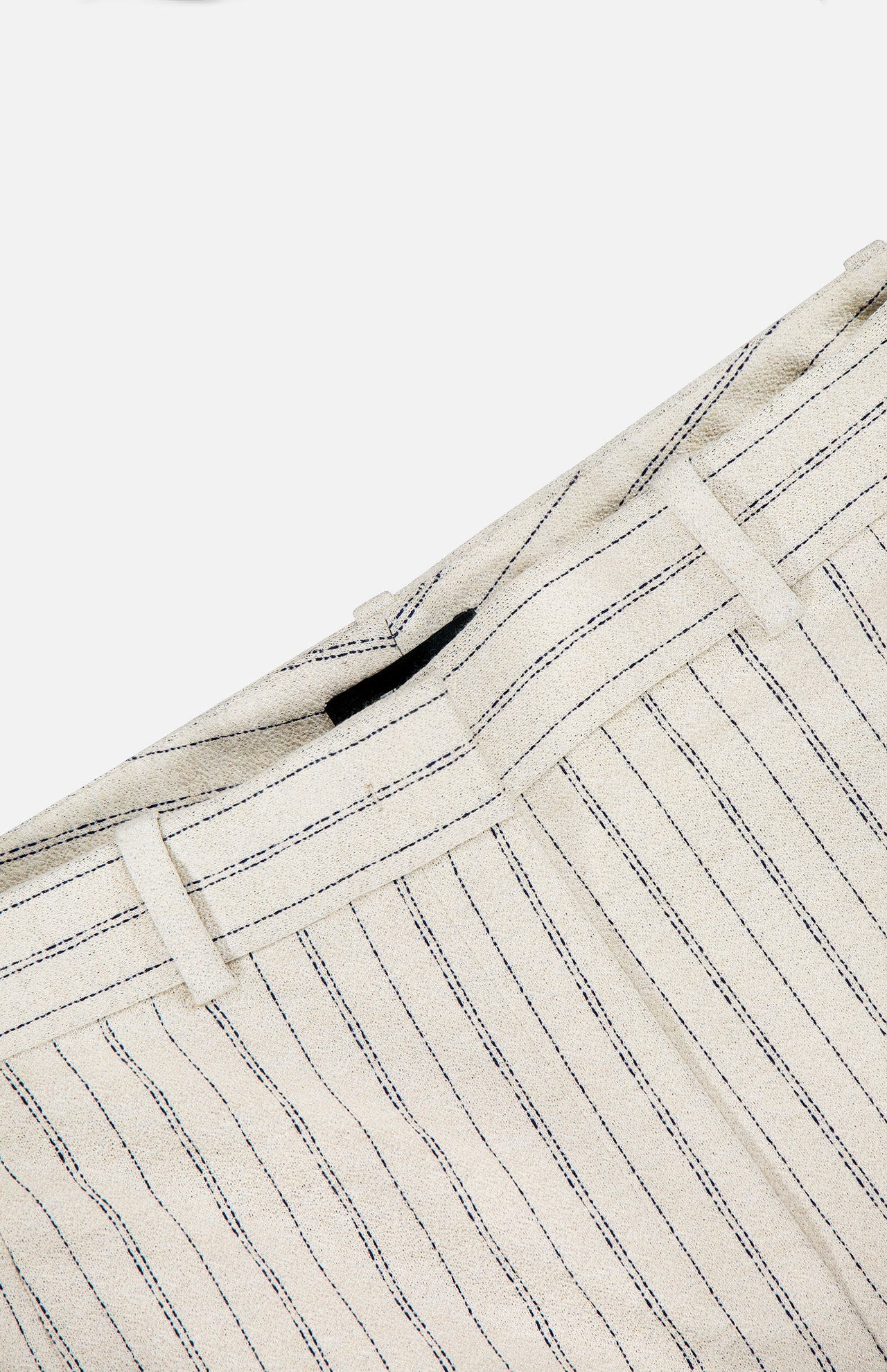 Close-up of the waistband on the THEORY Slim Full Length Trouser Pant in light beige crepe with thin navy pinstripes, belt loop, and partial seam, shown against a plain white background.