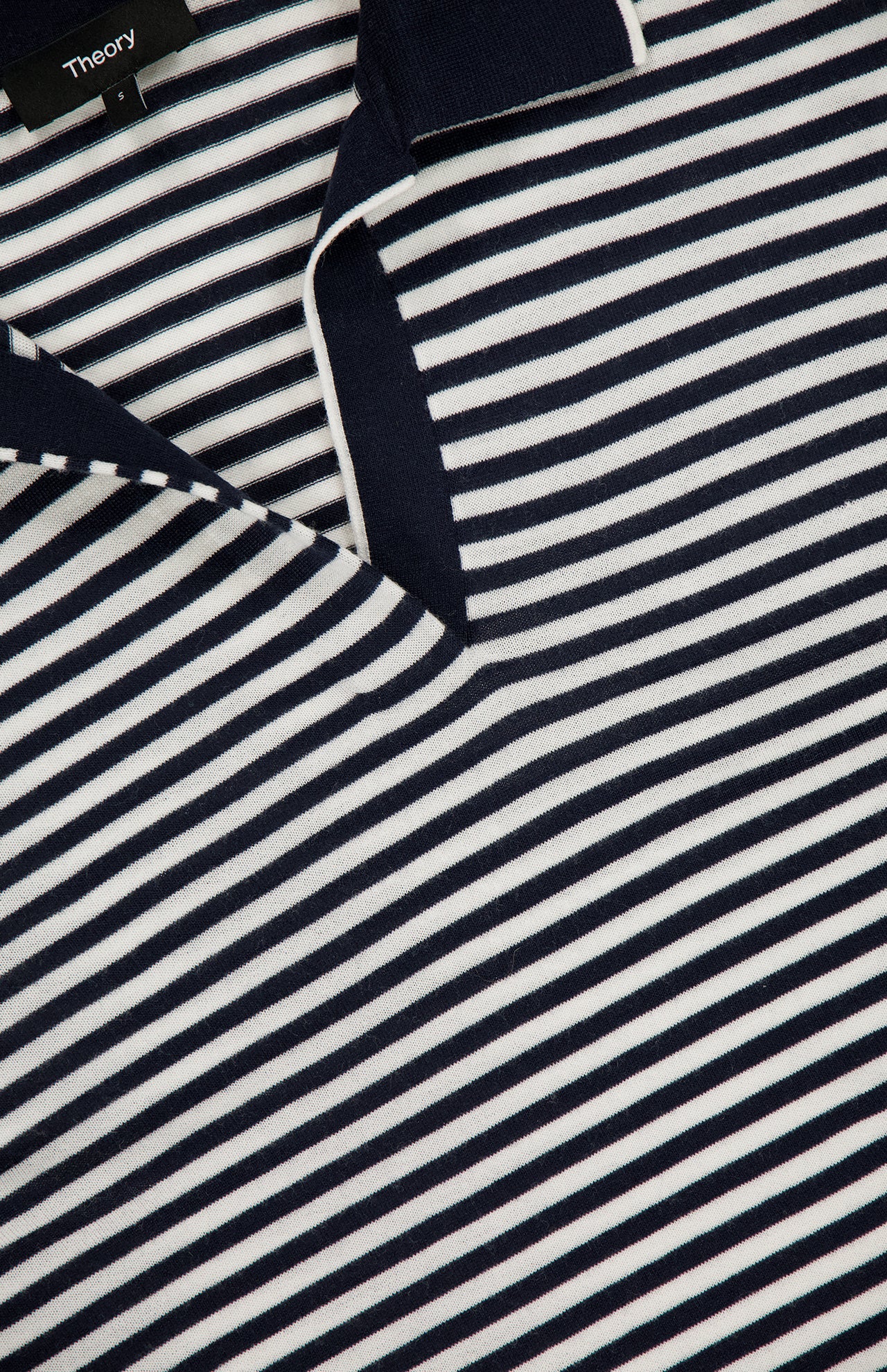 Close-up of the Stripe Boy Long Sleeve Shirt by THEORY, featuring navy stripes, white accents, and a V-shaped neckline. The THEORY label is visible near the collar, highlighting this stylish nautical summer top.