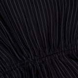 Close-up of the THEORY Tie Easy Stripe Tank Top in black with thin white vertical pinstripes and ruched stitching across the middle, perfect for a matching work set or pairing with black separates for a coordinated look.