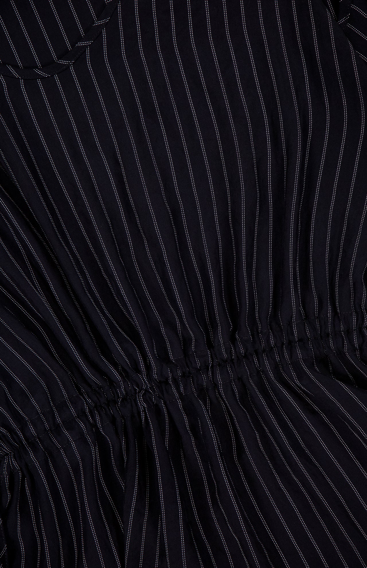 Close-up of the THEORY Tie Easy Stripe Tank Top in black with thin white vertical pinstripes and ruched stitching across the middle, perfect for a matching work set or pairing with black separates for a coordinated look.