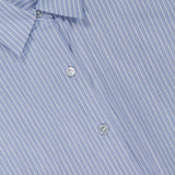 Close-up of the Tie Front Striped Short Sleeve Blouse by THEORY, featuring blue fabric with crisp white vertical stripes, a classic collar, three visible buttons, and a label at the neckline for a contemporary take on the timeless button-up style.