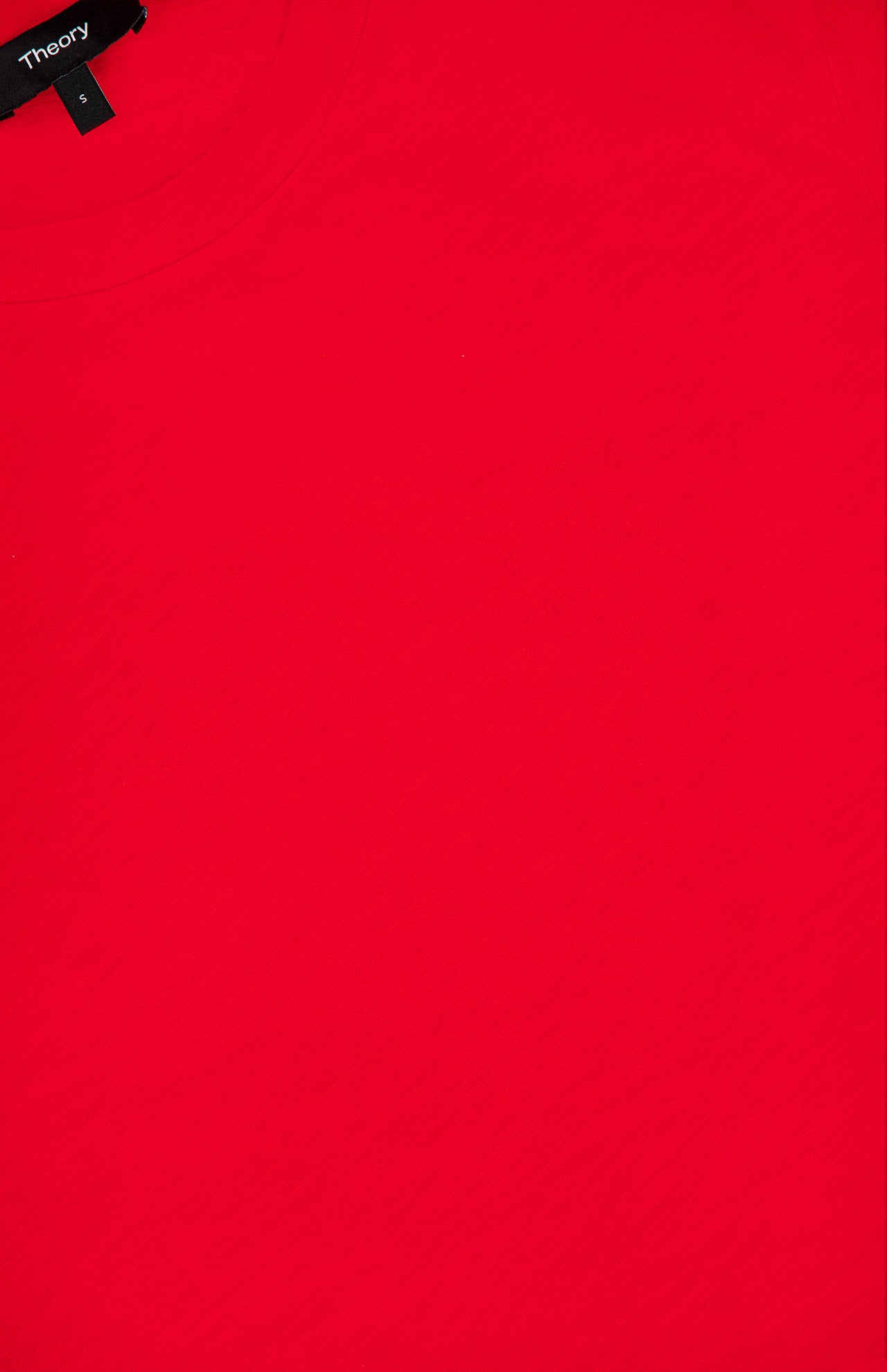 A close-up of the Tiny Cotton T-shirt in vibrant red showcases its fitted silhouette, with a visible black THEORY tag in the top left corner. Made from soft Pima cotton, this tee seamlessly combines comfort and style.