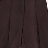 The Treeca Pull-On Pant by THEORY features a dark brown tailored design with a smooth front, side pockets, and subtle crease lines down each leg. These slim fit wool pants are perfect for office wear, offering both style and comfort with a partially elasticized waistband at the back.
