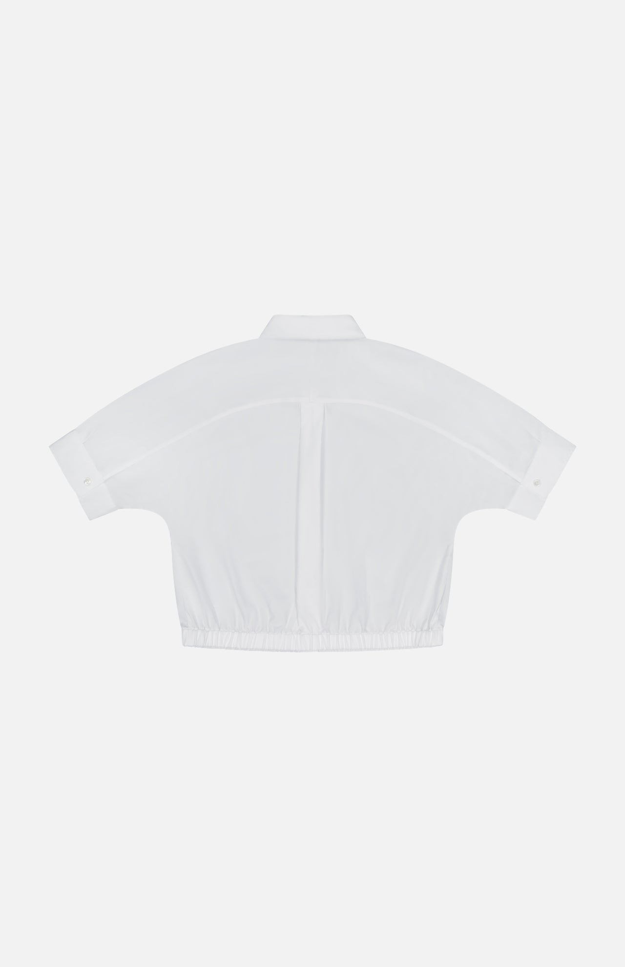 Back view of the THEORY Yoke Elastic Short Sleeve Shirt in white, featuring a cropped elastic hem and buttoned cuffs. Displayed on a plain white background—ideal for casual travel wear.
