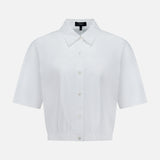The THEORY Yoke Elastic Short Sleeve Shirt features a button-up front, collar, and slightly cropped elastic hem in white—ideal for casual travel. Shown on a plain white background.