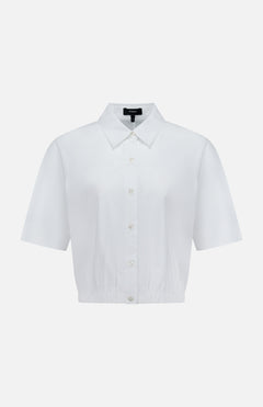 The THEORY Yoke Elastic Short Sleeve Shirt features a button-up front, collar, and slightly cropped elastic hem in white—ideal for casual travel. Shown on a plain white background.