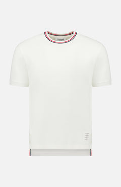 The THOM BROWNE Cotton Waffle Rib Cuff Short Sleeve T-shirt features soft cotton waffle fabric, a ribbed crew neck and cuffs, red-white-blue stripe accents at the collar and hem, and a small label near the left bottom hem.