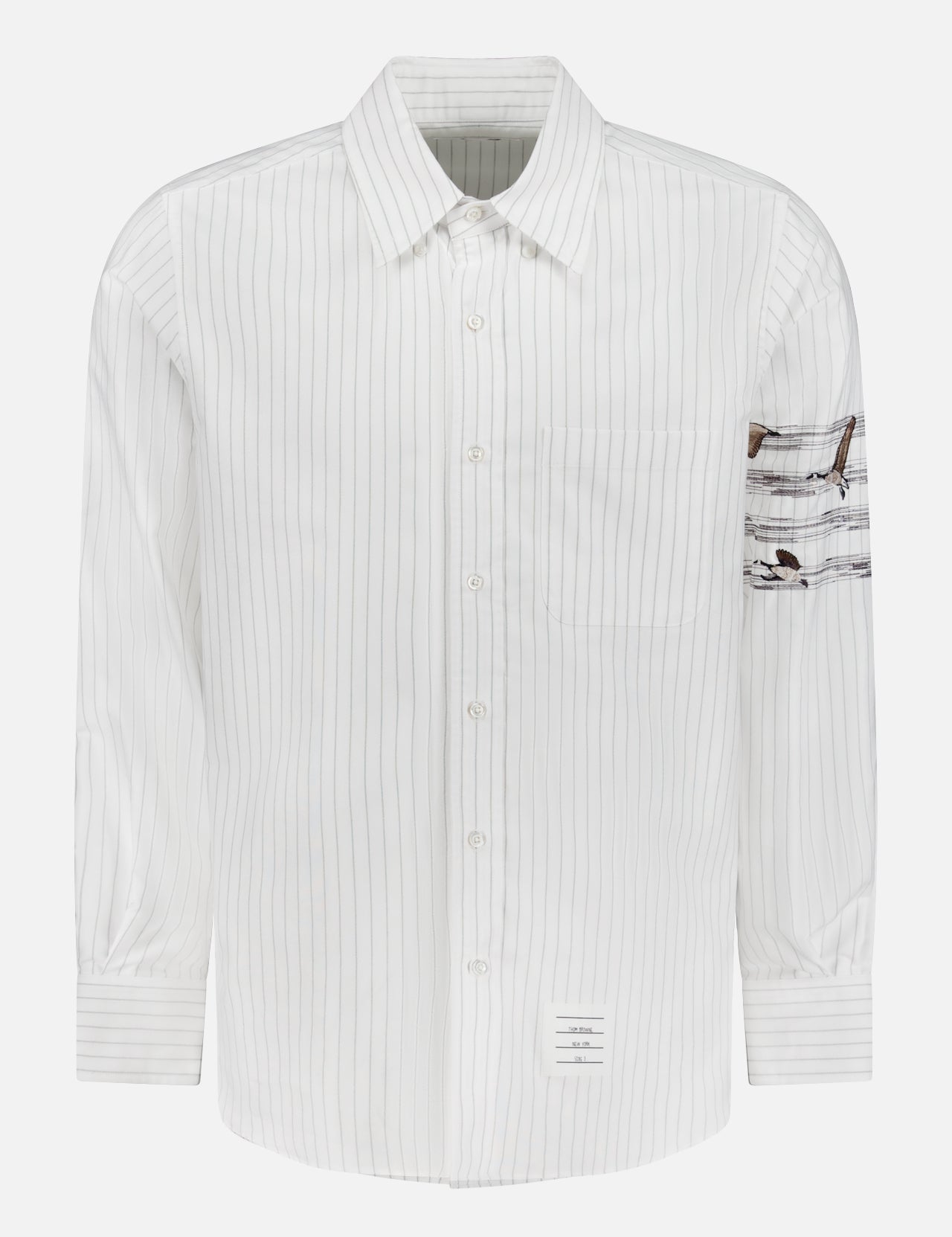 The Pencil Stitch Geese Straight Fit Shirt by THOM BROWNE is a men's striped shirt with thin gray vertical lines, a chest pocket, and Americana details including brown geese patch on the left sleeve and a small label above the hem.