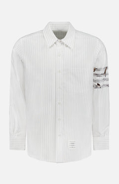 The Pencil Stitch Geese Straight Fit Shirt by THOM BROWNE is a men's striped shirt with thin gray vertical lines, a chest pocket, and Americana details including brown geese patch on the left sleeve and a small label above the hem.