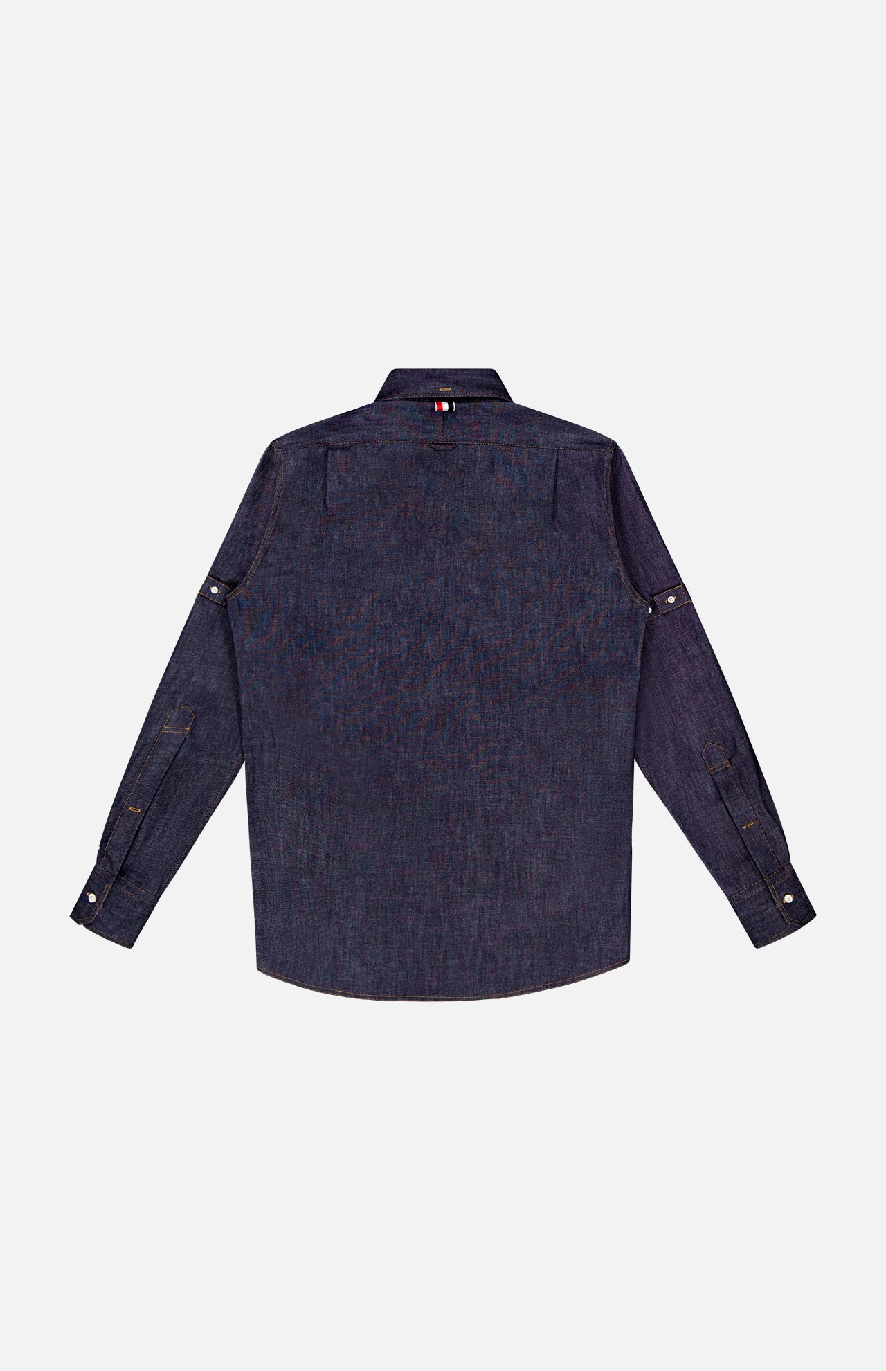 The THOM BROWNE Denim Long Sleeve Button Down Straight Fit Shirt for men, in dark blue cotton, features buttoned cuffs and a red, white, and blue striped tag below the collar. Shown flat from the back on a white background for a classic look.